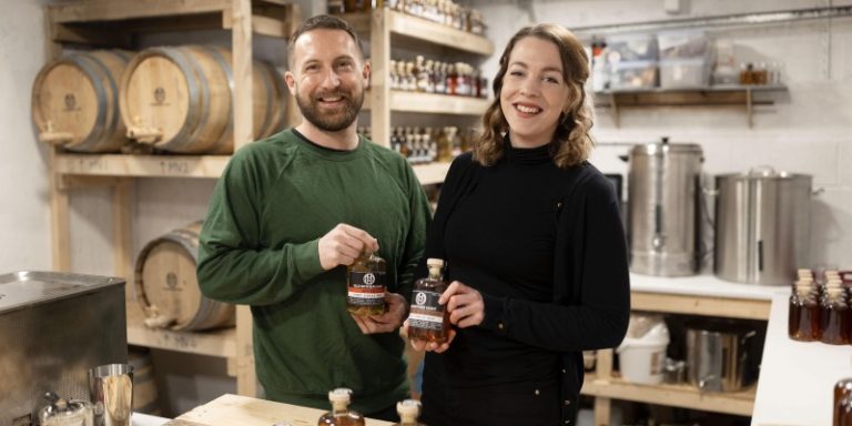 founders holding bottles