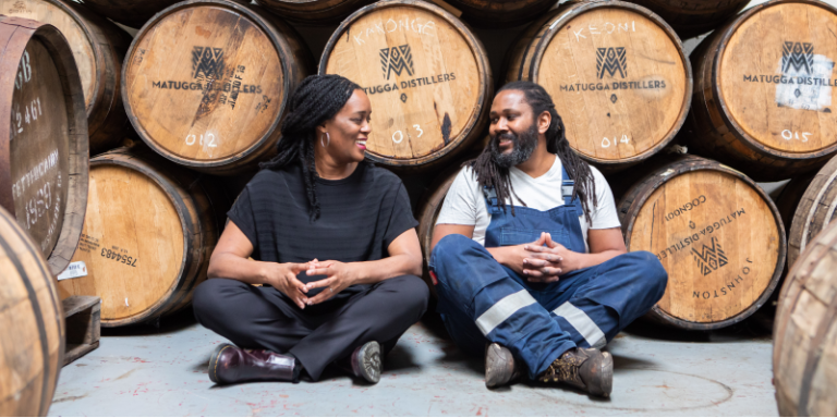 man and woman in front of casks