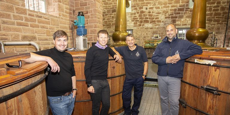 Four men in a distillery