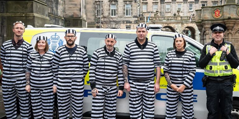 People in stripy prison uniforms